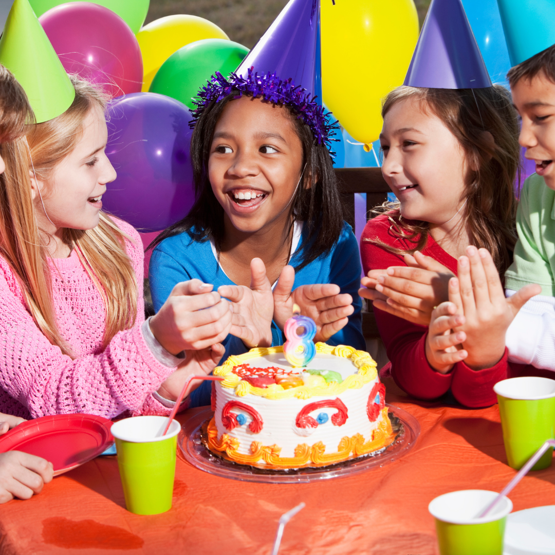 kids sitting and celebrating a birthday party